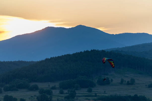 istock Paragliding at sunset with amazing view 1163760135