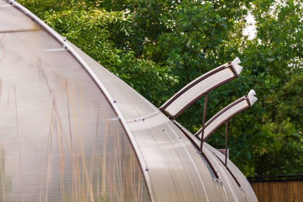 Broken polycarbonate greenhouse in the country after a snowy winter