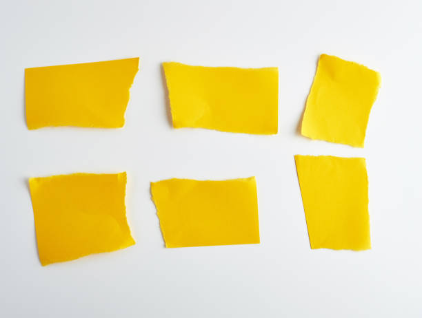 istock empty torn pieces of yellow paper on a white background 1163763976