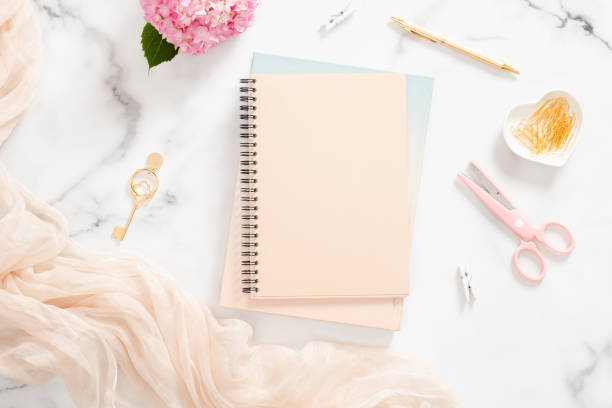 istock Flatlay home office desk table with blank paper notebook, pink hydrangea flower, pastel blanket and stylish accessories on marble background. Feminine background, fashion blogger workspace concept 1163764107