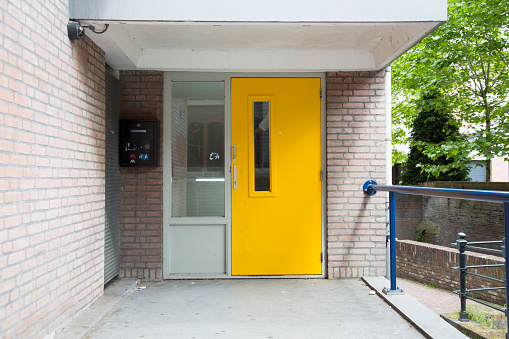 's-Hertogenbosch, The Netherlands - May 2019. View of an old eighties house front with yellow door in the center of Den Bosch, The Netherlands.
