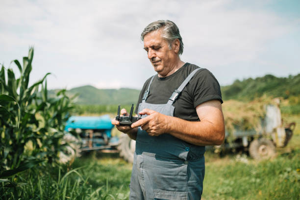 istock Mature farmer flying a drone over a field 1163765395