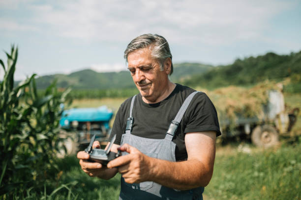 istock Mature farmer flying a drone over a field 1163765524