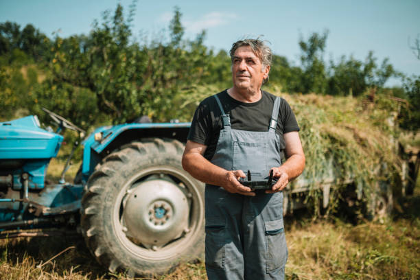 istock Mature farmer flying a drone over a field 1163765600