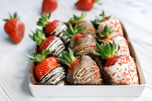 istock Ripe tasty strawberries covered with white and brown chocolate 1163767385