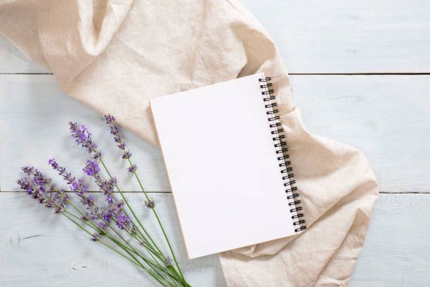 istock Flatlay composition with blank paper notepad, lavender flower, pastel beige blanket on rustic blue wooden background. Flat lay, top view still life concept. 1163768497