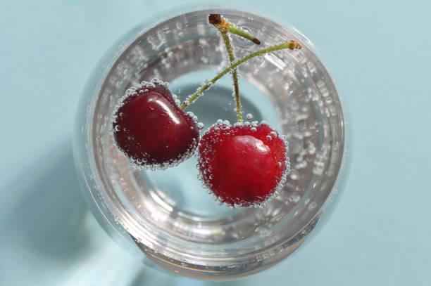 istock Glass of water and fresh cherries with bubbles 1163768736