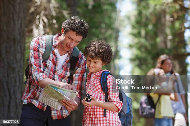 Father And Son Looking At Map In Woods Stock Photo - Download Image Now - Hiking, Map, Child