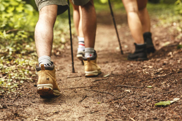 istock People hiking.Only legs and tracking boots are visible. 1163771730