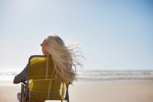 Womans hair blowing in wind on beach