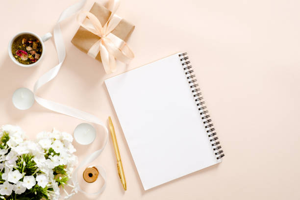 istock Romantic flatlay composition with diary, gift box, flowers bouquet, ribbon, candles, tea cup on pastel pink background. Flat lay, top view, copy space. Girls diary concept 1163772415