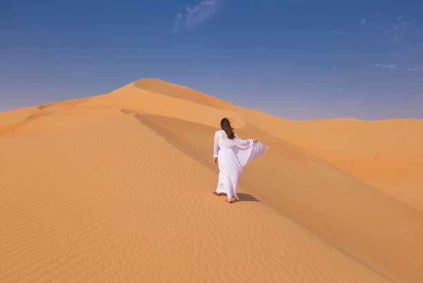 istock UAE. Woman in desert 1163773664