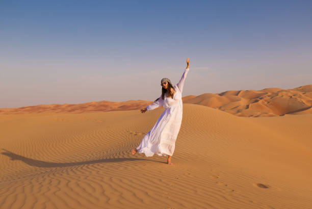 istock UAE. Woman in desert 1163773692