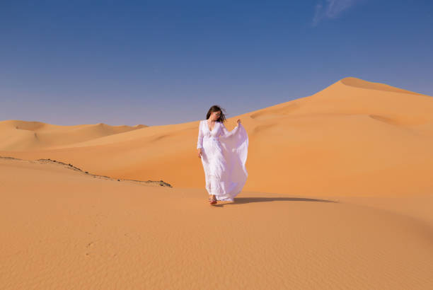 istock UAE. Woman in desert 1163774613