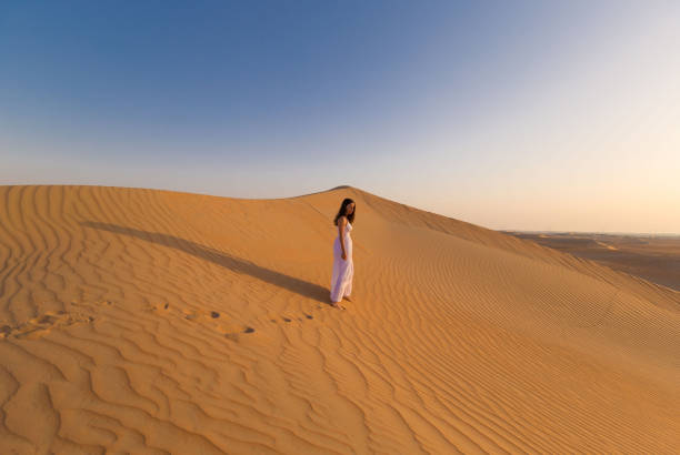 istock UAE. Woman in desert 1163774682