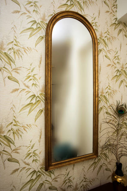 istock Long vintage mirror on wall with wallpaper and peacock feather antique retro design 1163774902