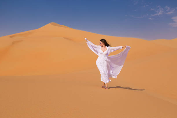 istock UAE. Woman in desert 1163775074