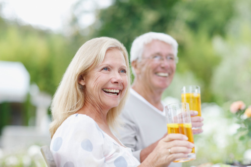 Happy elderly couple health care in park , relax asian older man and woman celebrate anniversary drink wine and smile ,People lifestyle concept.