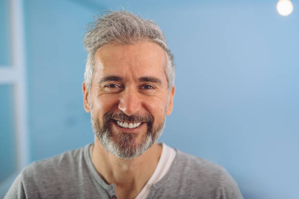 happy middle aged gray haired bearded man happy middle aged gray haired bearded man smiling 40 44 years stock pictures, royalty-free photos & images