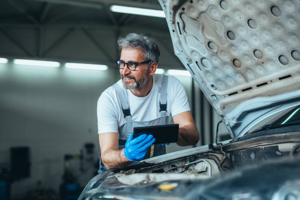car service concept worker using tablet for car diagnostic service car engineer stock pictures, royalty-free photos & images