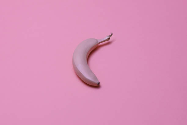 istock Pink painted big banana on the pink smooth isolated surface 1163776146
