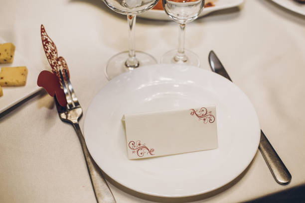 istock empty card on plate on table with cutlery, setting at wedding reception in restaurant, luxury catering. menu or guest invitation 1163779935