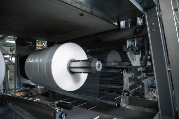 istock Plastic roll in industrial food packaging machine equipment tool at factory workshop 1163781367