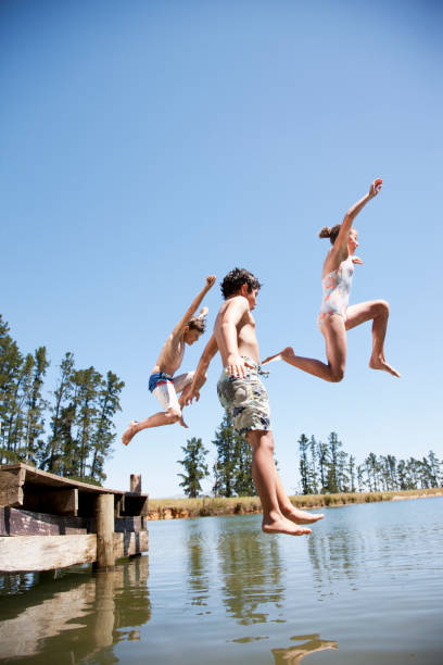 Kids jumping in lake  jumping into water stock pictures, royalty-free photos & images