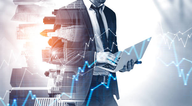 istock Businessman with laptop in city, graph 1163784384
