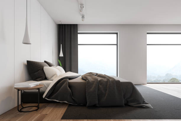 istock Side view of loft white master bedroom 1163784509