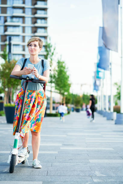 istock Business woman using electric scooter 1163785233