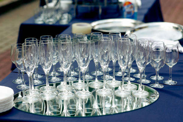 istock champagne glasses on table at wedding reception outdoors. empty glasses for champagne drinks on tray at celebration in park 1163785681
