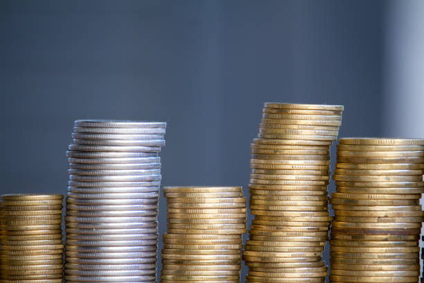 Close-up of columns of multi-colored coins of increasing height, the concept of saving and saving money, selective focus Closeup of columns of multi-colored coins of increasing height, the concept of saving and saving money, selective focus gold ira companies gold and silver stock pictures, royalty-free photos & images