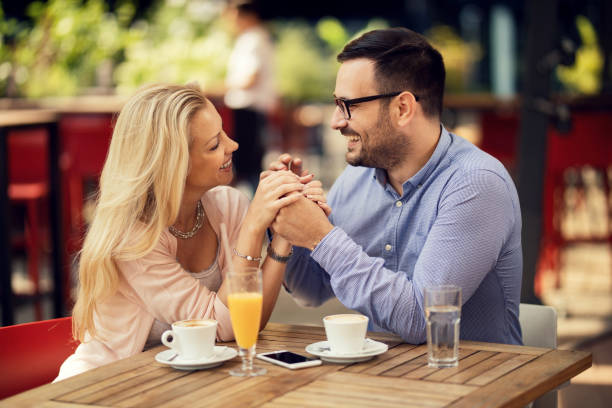 istock Happy couple in love talking while holding hands in a cafe. 1163787049