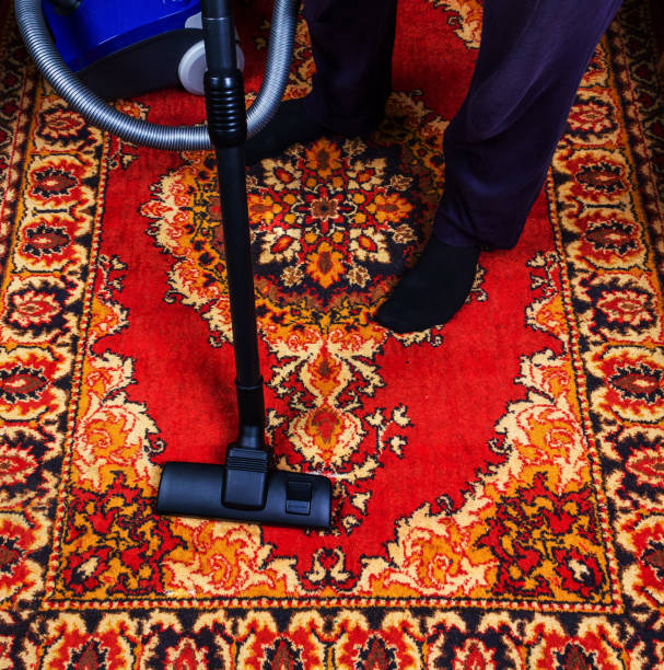 istock a man is vacuuming an old carpet 1163787077