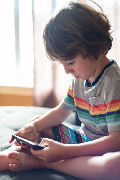 istock Boy Plays on Smart Phone 1163787220