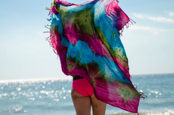 istock Woman back with colorful big scarf on wind 1163789550