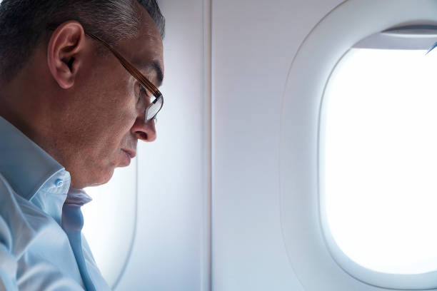 istock Businessman sleeping traveling by airplane 1163791242