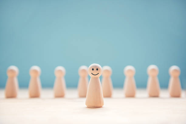 happy wood people symbol standing out from the crowd. - individuality standing out from the crowd contrasts competition imagens e fotografias de stock