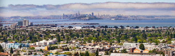 panoramic view of berkeley; san francisco, treasure island and the bay bridge visible in the background; california - bay san francisco county residential district aerial view imagens e fotografias de stock