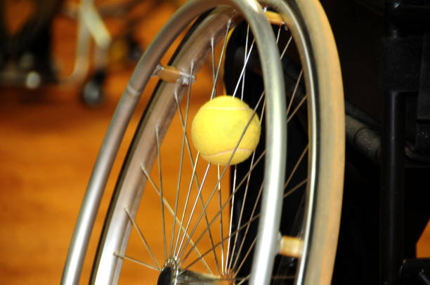 "nphysically disabled athlete playing tennis in wheelchair "nphysically disabled athlete playing tennis in wheelchair wheelchair tennis stock pictures, royalty-free photos & images