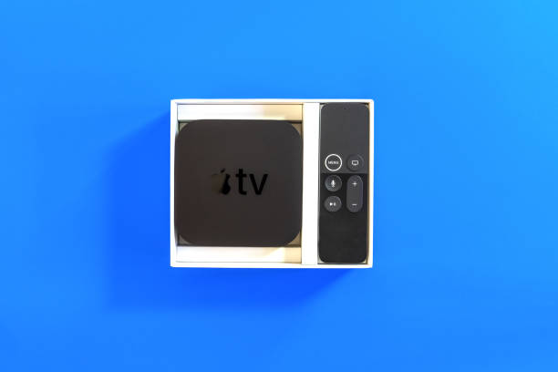 apple tv with remote control in box - remote television movie box imagens e fotografias de stock