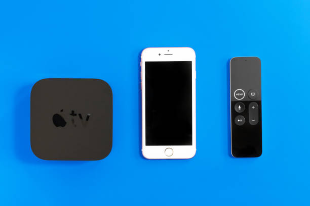 New Apple TV media streaming player microconsole by Apple Computers. It has new touch remote swipe-to-select with integrated Siri and motion sensor. And iphone 8 ROSTOV-ON-DON, RUSSIA - DECEMBER 20, 2018: New Apple TV media streaming player microconsole by Apple Computers. It has new touch remote swipe-to-select with integrated Siri and motion sensor. And iphone 8 4k gaming stock pictures, royalty-free photos & images