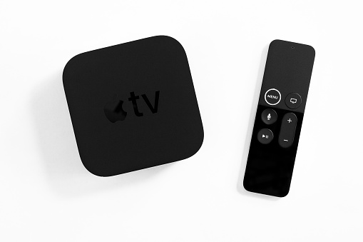 ROSTOV-ON-DON, RUSSIA - DECEMBER 20, 2018:  New Apple TV media streaming  player microconsole by Apple Computers - not isolated on white. It has new touch remote swipe-to-select with integrated Siri and motion sensor
