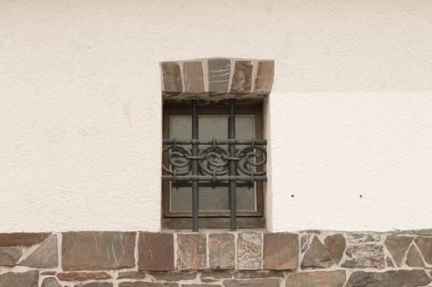 istock Isolated window with a wrought iron grate and bricks (Germany, Europe) 1163794107
