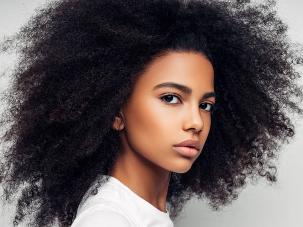 istock Beautiful smiling girl with curly hairstyle 1163799404