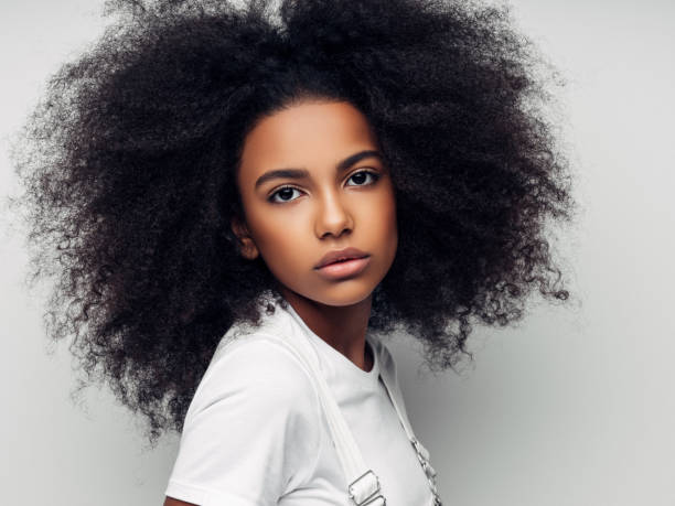 istock Beautiful smiling girl with curly hairstyle 1163799448