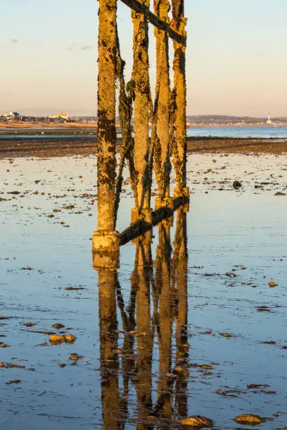 Reflections at low tide, on the beach at Worthing in Sussex