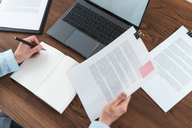 istock Woman working behind wooden table in office 1163803764