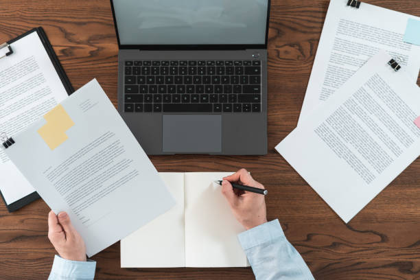 istock Woman working behind wooden table in office 1163803772